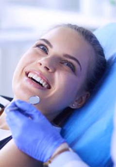 Woman smiling at her dentist during checkup