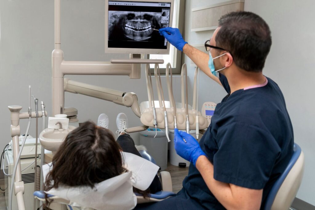 A dentist reviewing X-rays with a patient
