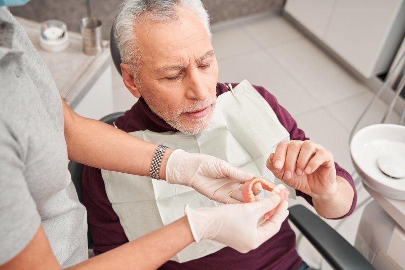 Man with dentures at the dentist