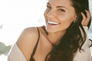 Close up of young woman smiling in the sun